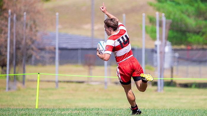 Rio Grande's Ethan Manuel raises his hand skyward after scoring a second half try in Sunday afternoon's matchup with Marian University at Red Valley Pitch. The Knights parlayed a fast start into a 41-30 win over the RedStorm.