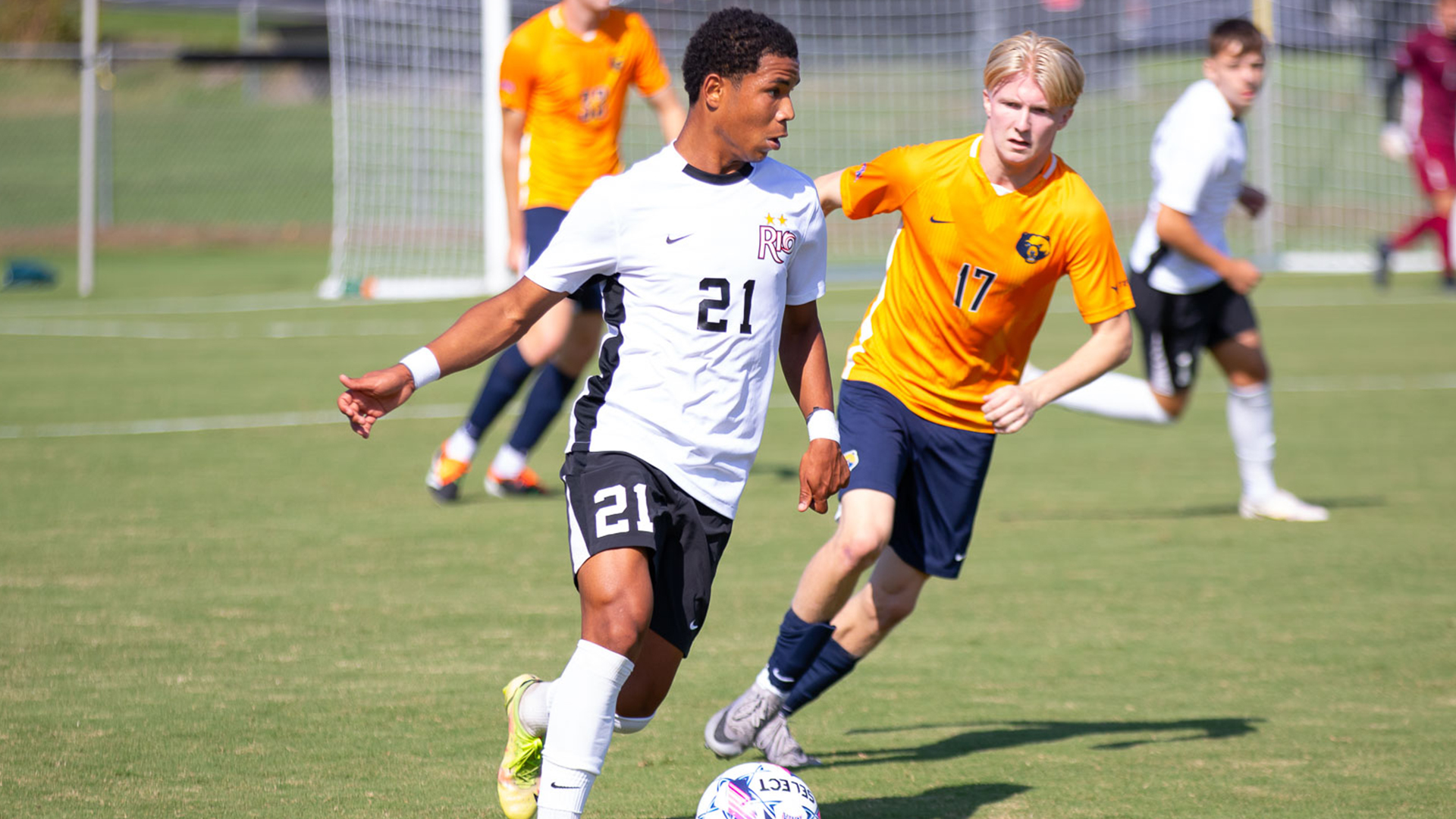 Rio Grande's Estevao Goncalves runs past WVU-Tech's Lorenz van den Berg during Saturday morning's River States Conference Men's Soccer Match of the Week at Evan E. Davis Field. The RedStorm blanked the Golden Bears, 1-0.