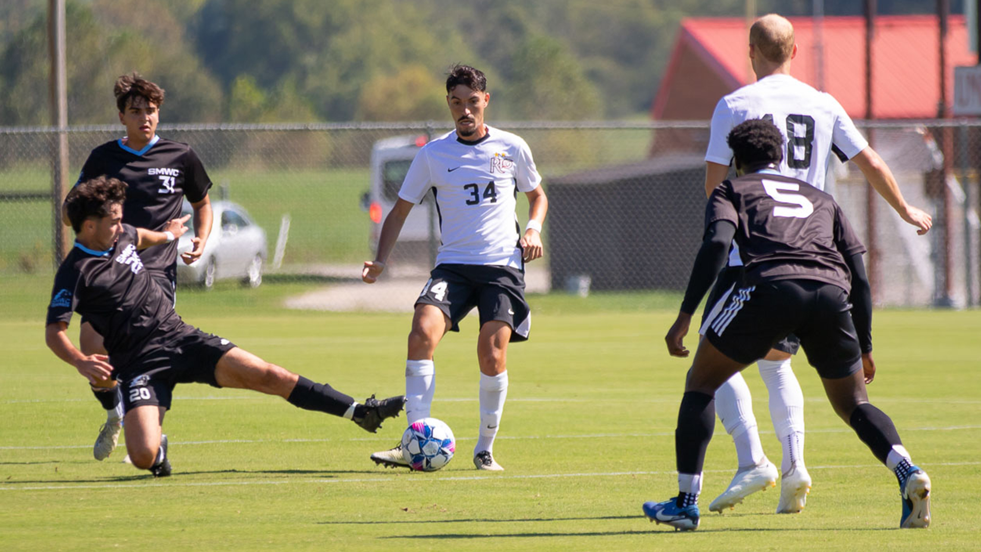 Rio Grande's Daniel Christofi keeps the ball away from a St. Mary-of-the-Woods defender during Thursday afternoon's 3-1 win over the Pomeroys at Evan E. Davis Field.