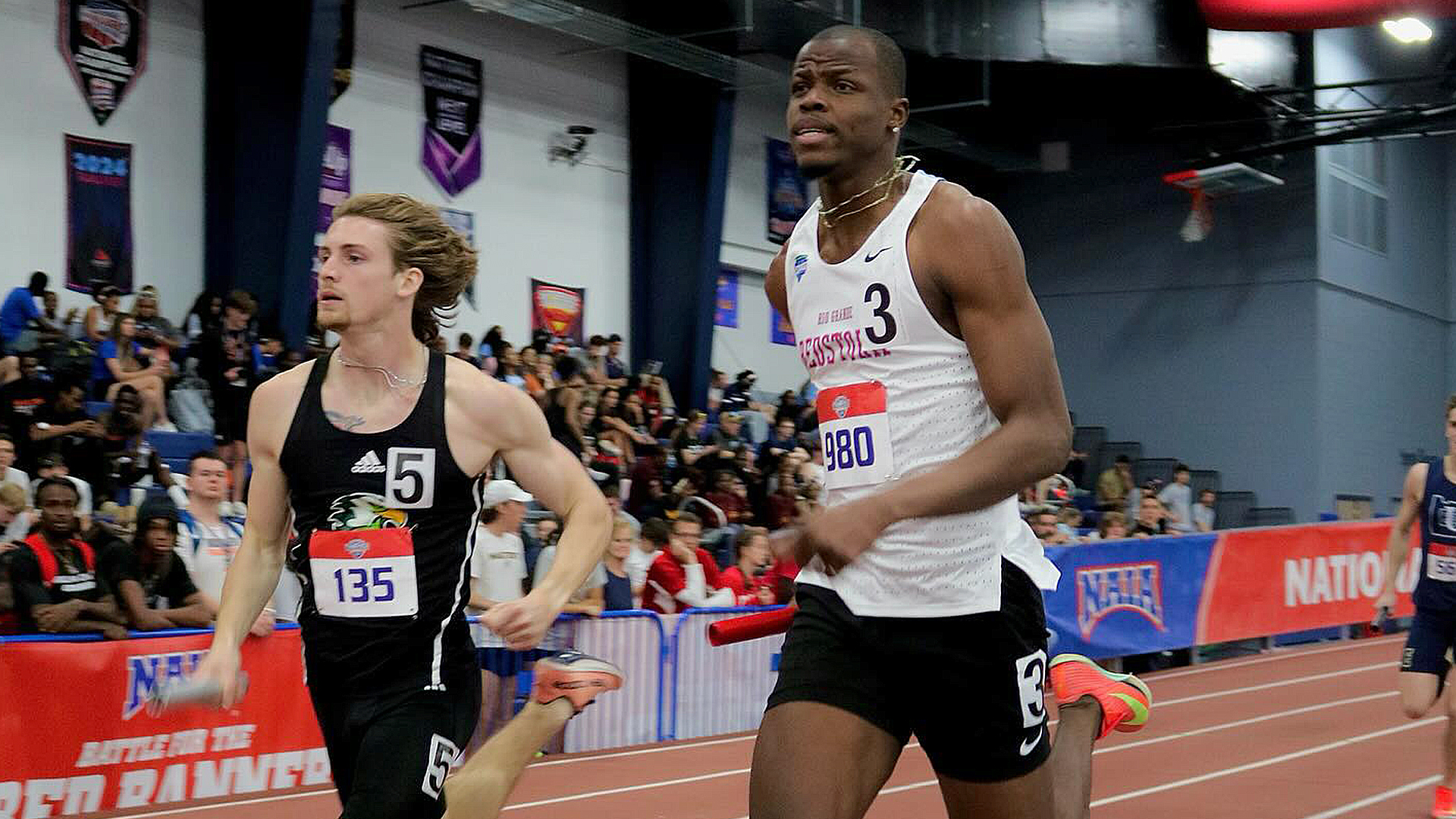 Rio Grande's Troy Mason (white top) runs during Thursday's Men's 4x400 relay preliminaries at the NAIA Indoor Track and Field Championships in Gainesville, Fla.